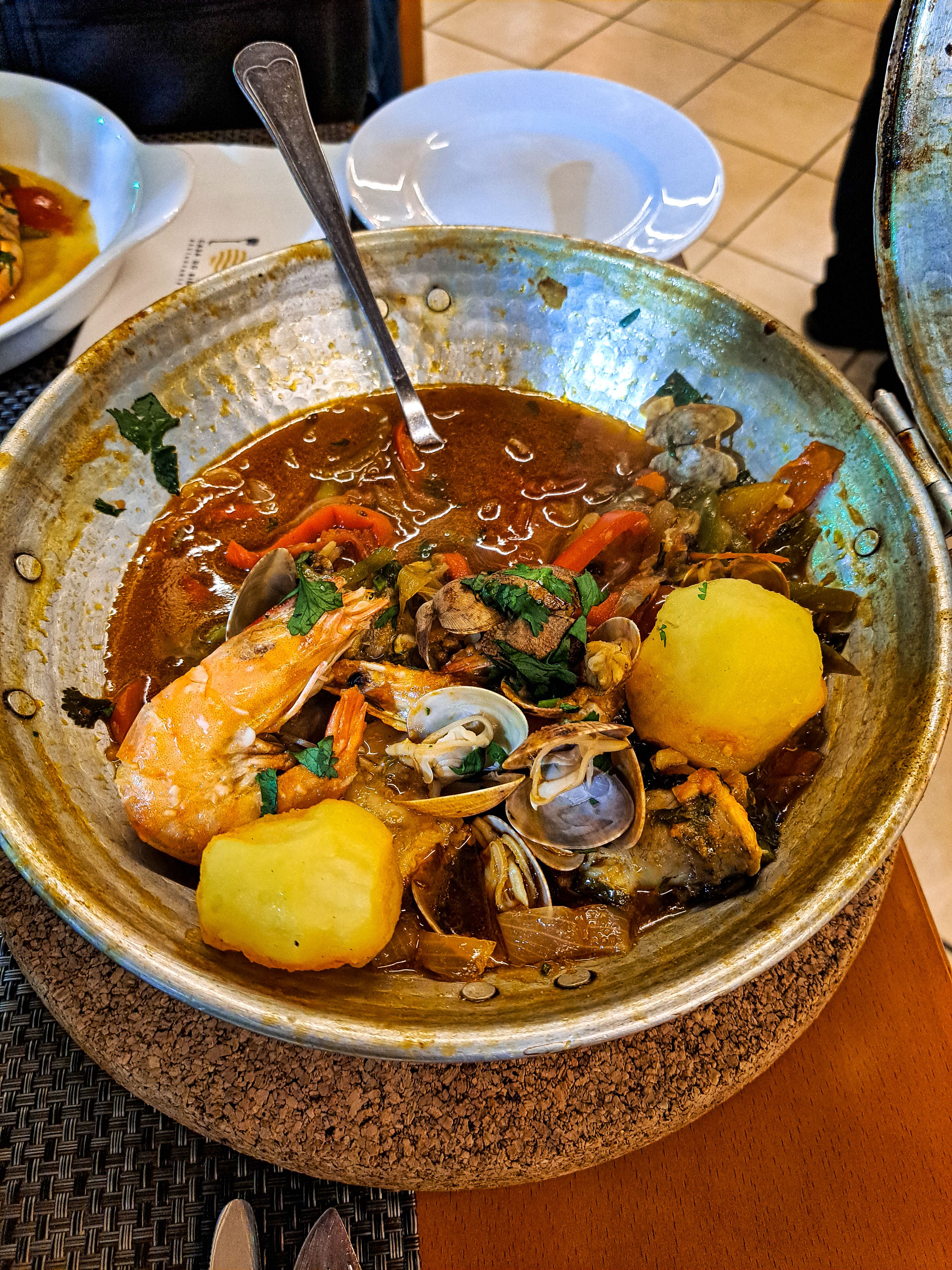 Traditional portuguese dish Cataplana cooked and served in a domed copper pot. Algarve, southern Portugal