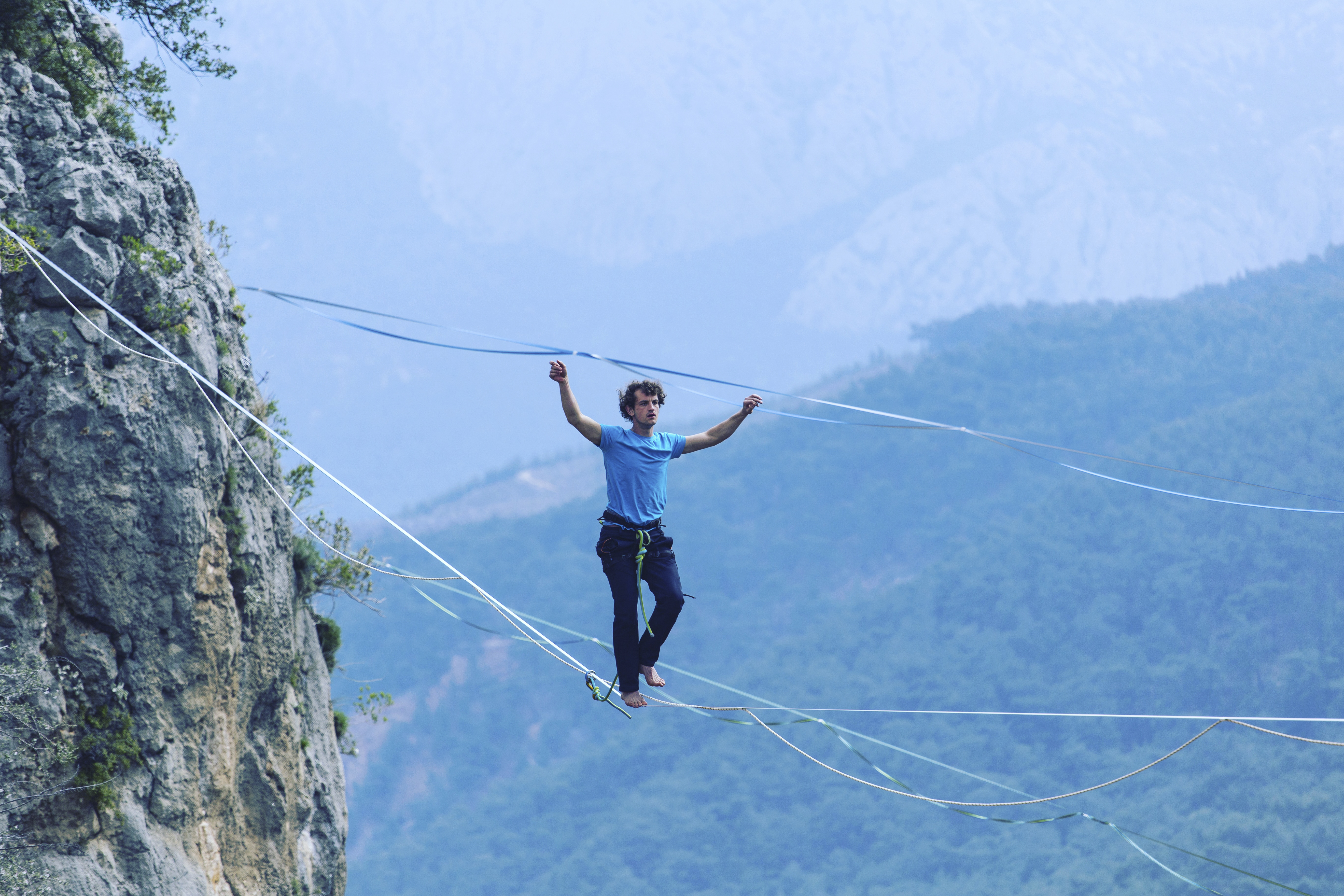 Man balancing on the rope concept of risk taking and challenge.