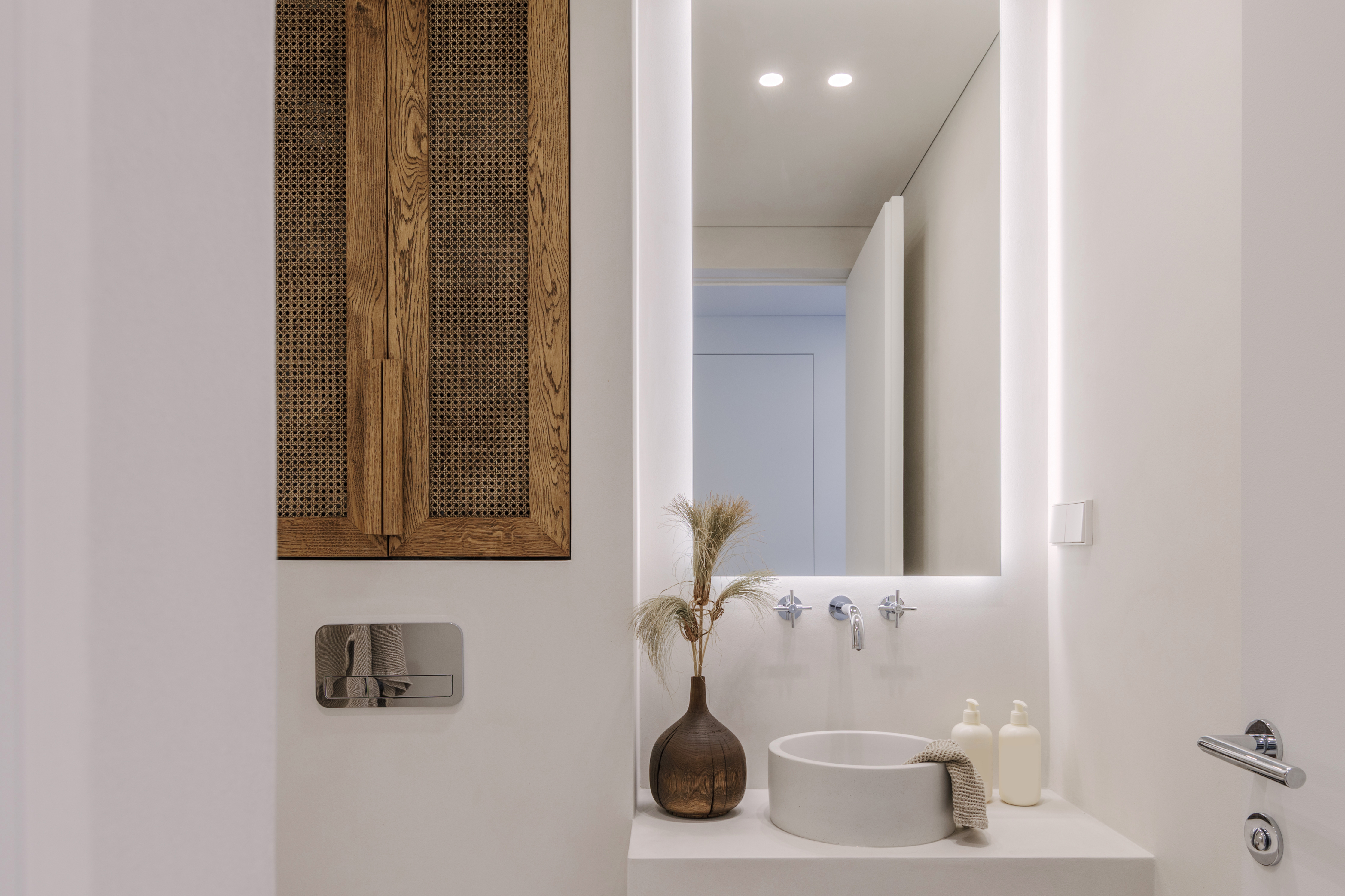 Aesthetic wabi sabi bathroom interior design in brown and off white shades with solid oak and rattan furniture. Microcement in bathroom. Slow living concept