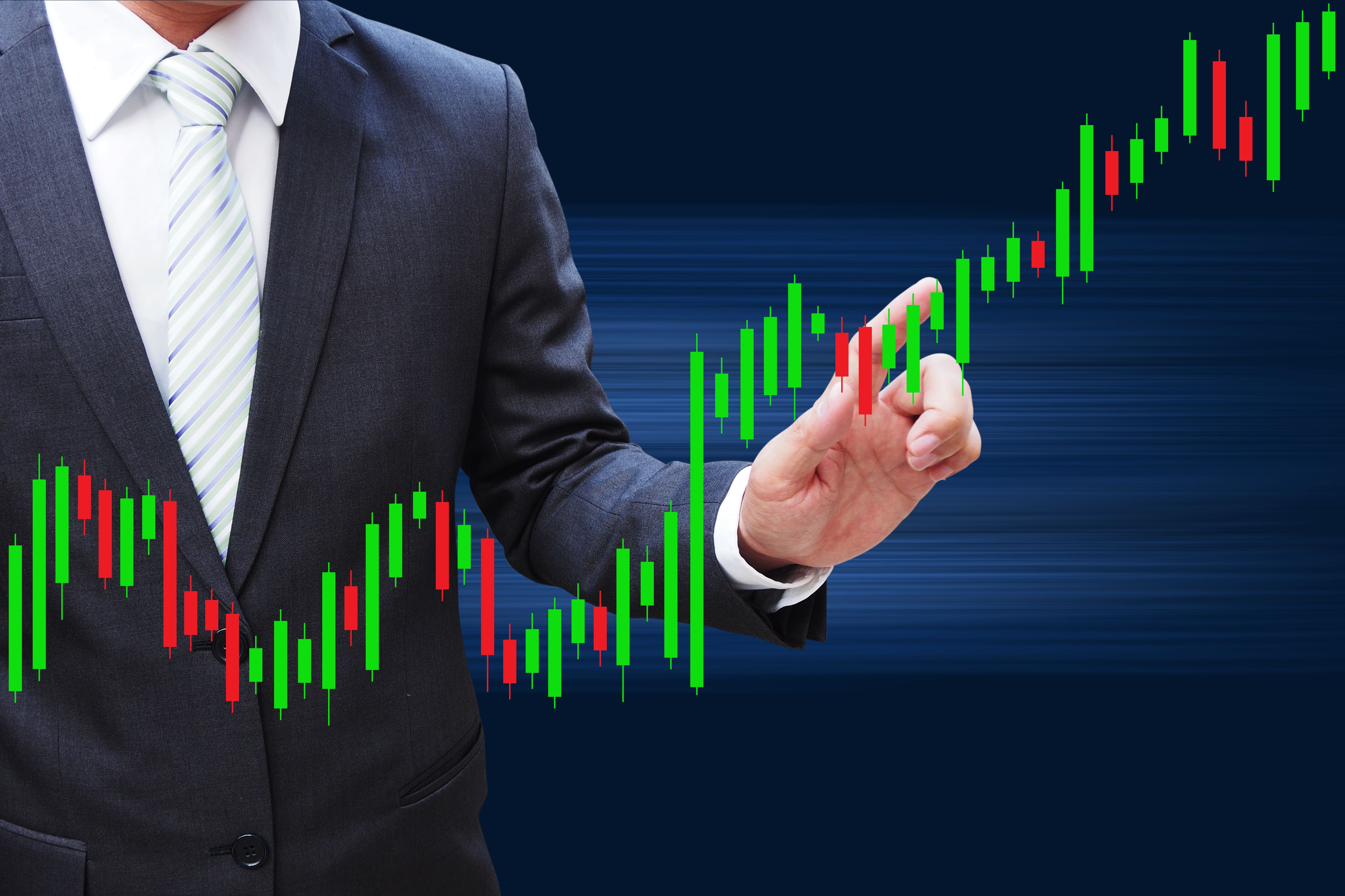 Businessman hand touching Candlestick Chart, investment concept