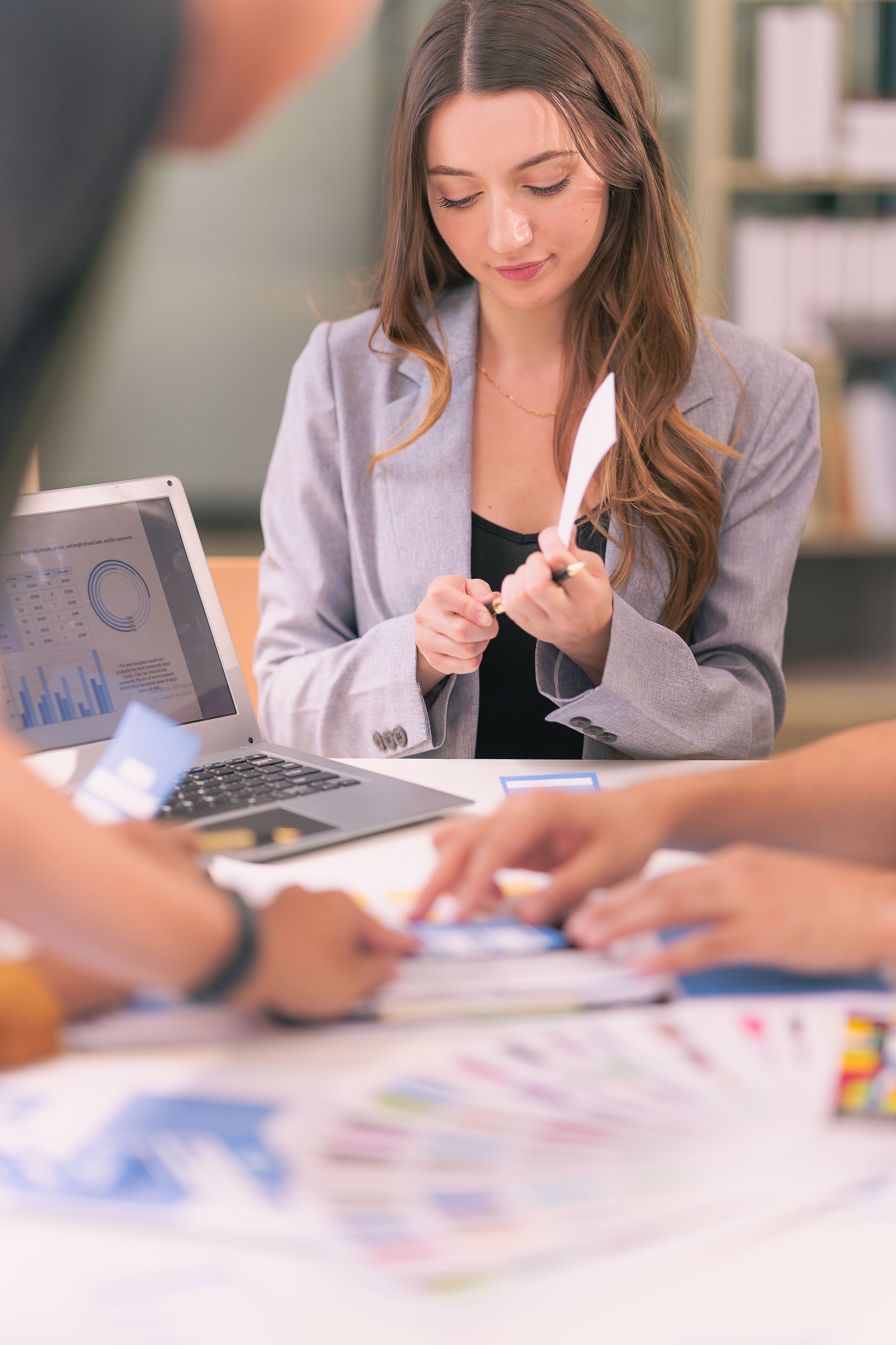 Group of business people designing product that represents the result of successful teamwork with graphic design working with tablet on desk in office.