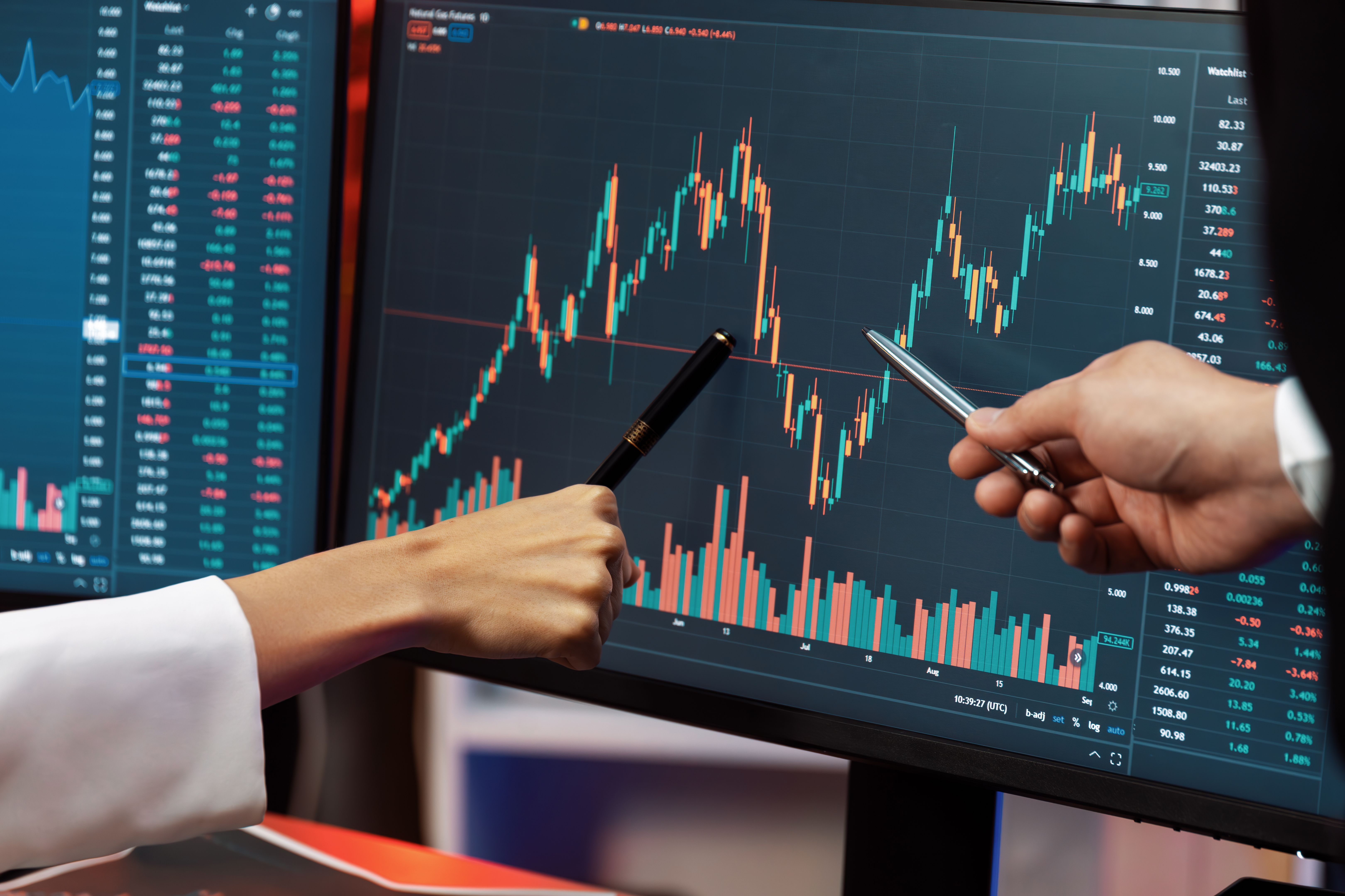 Cropped partners pointing by pen in stock market profit on computer. Infobahn.