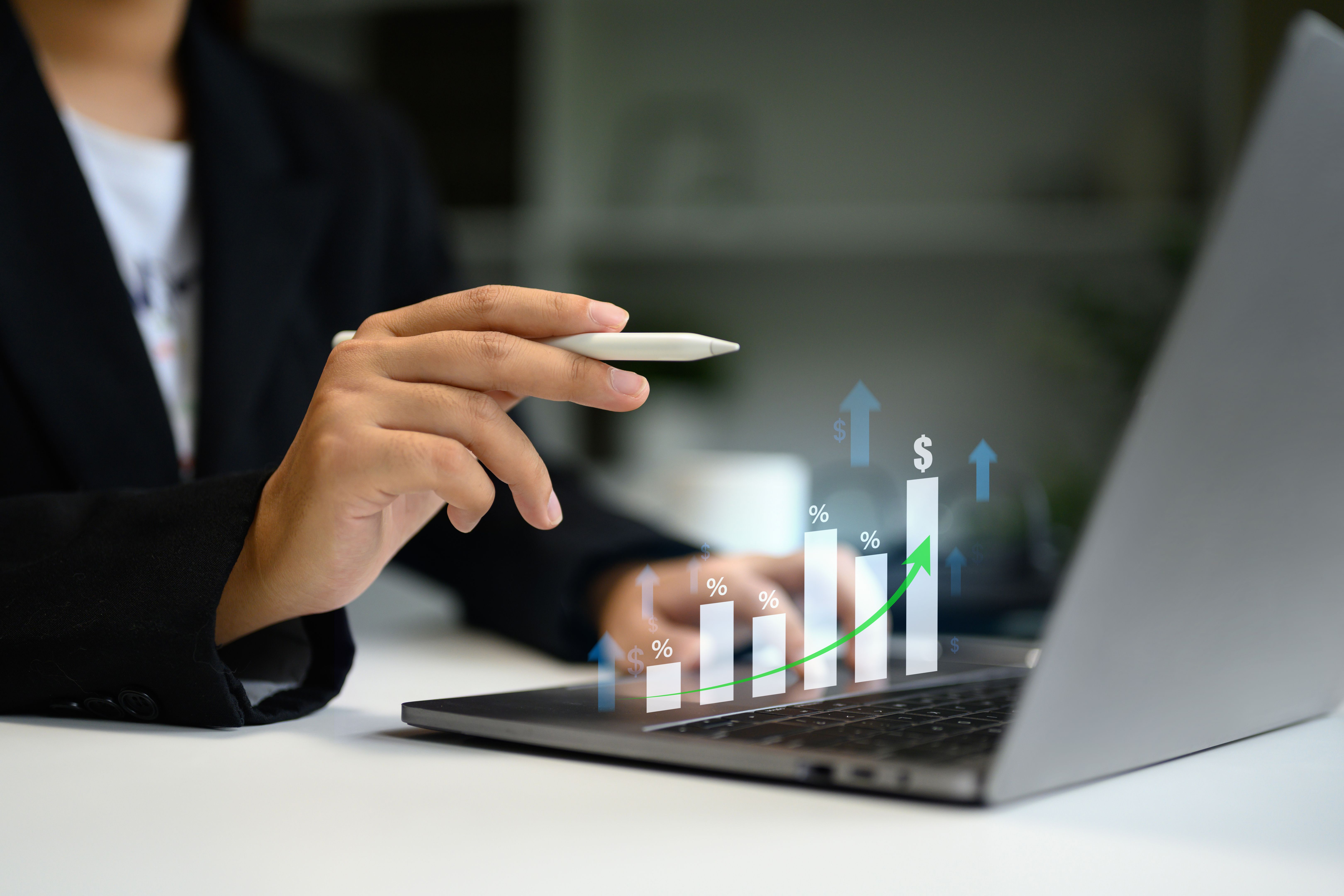 Business person reviewing online market performance with visual data projections and percentage growth