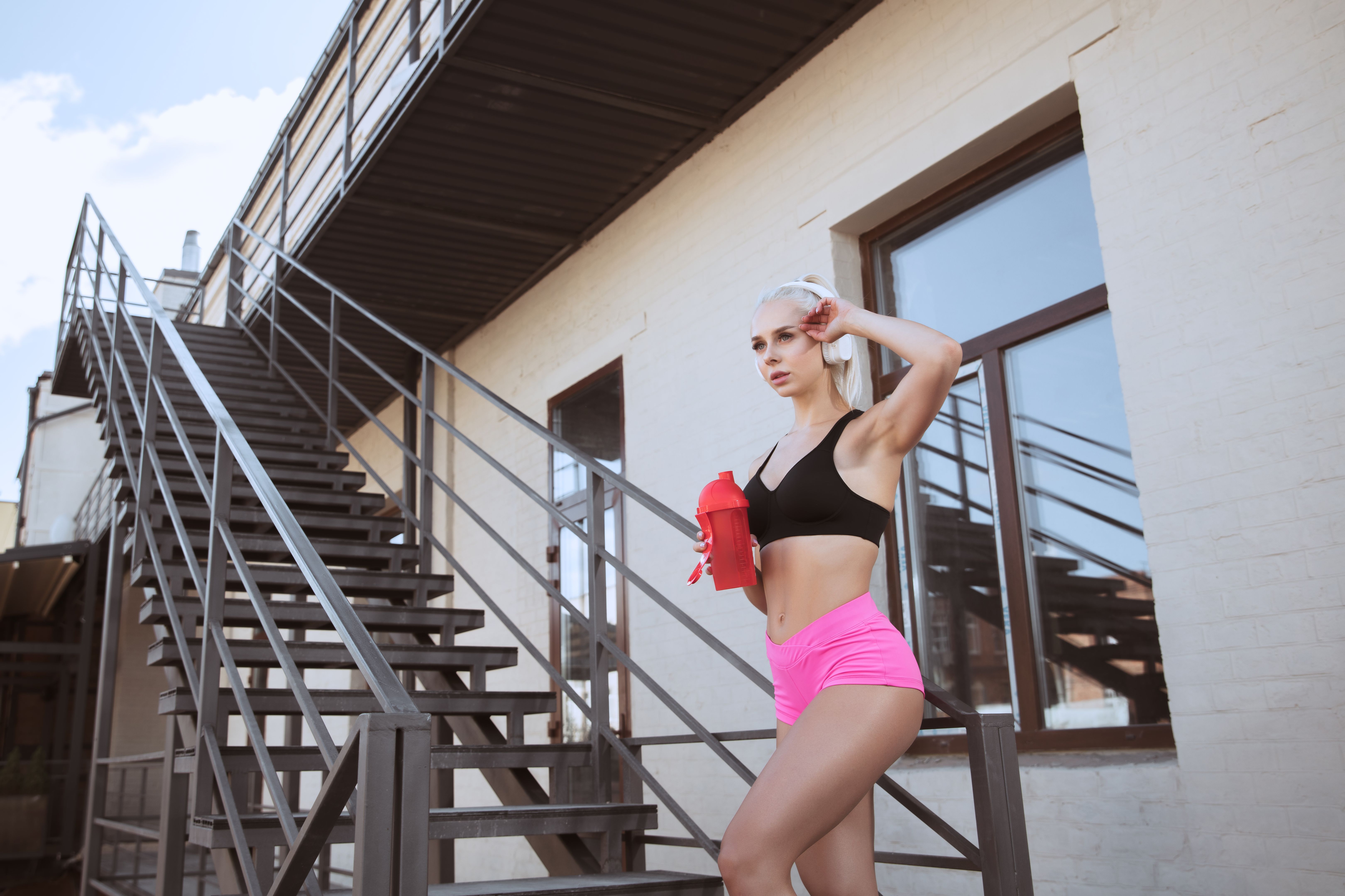 A young athletic woman working out on a stairs outdoors A young athletic woman working out on a stairs outdoors