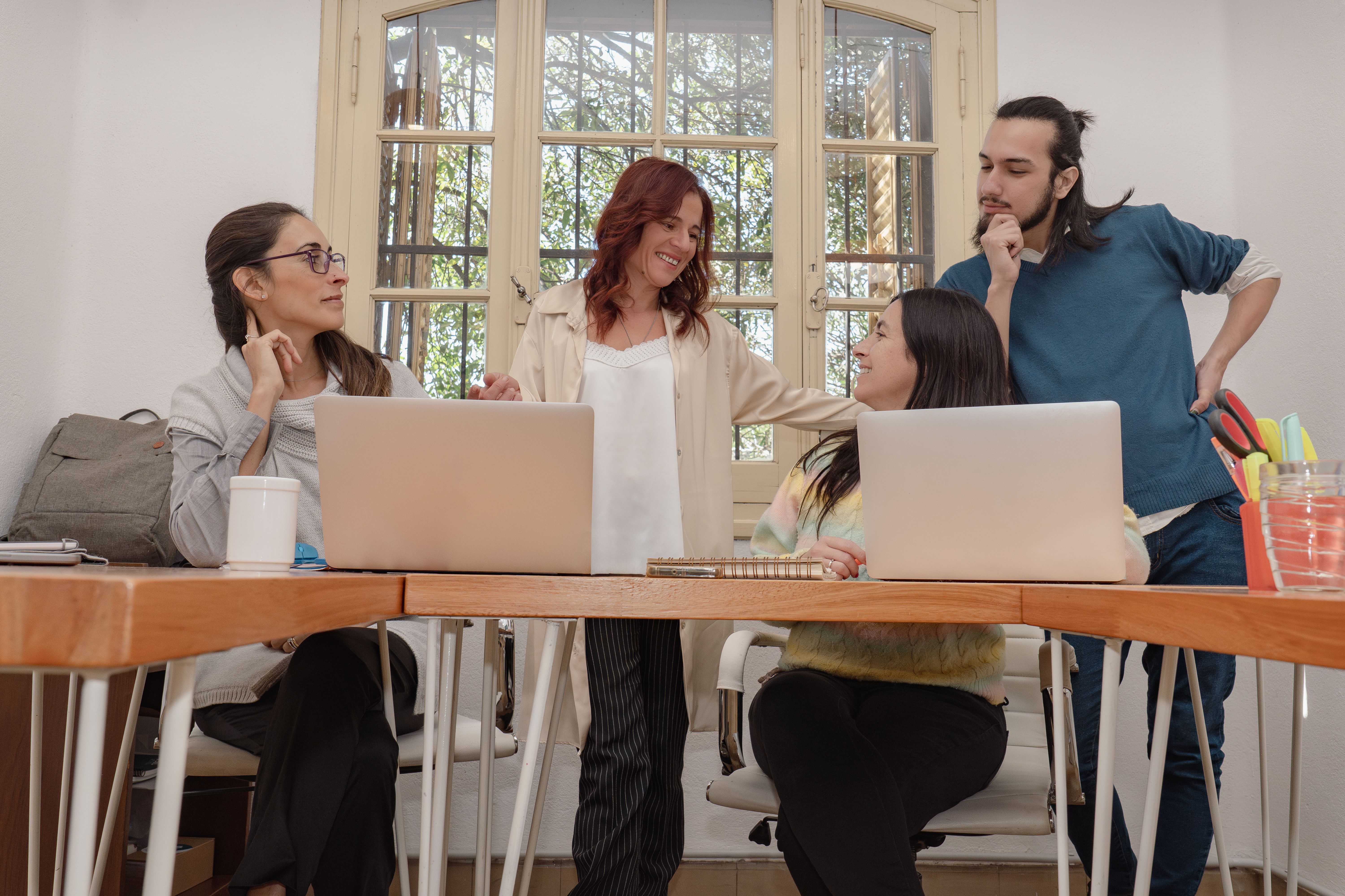 Diverse team meeting in a bright office. Diverse team meeting in a bright office.