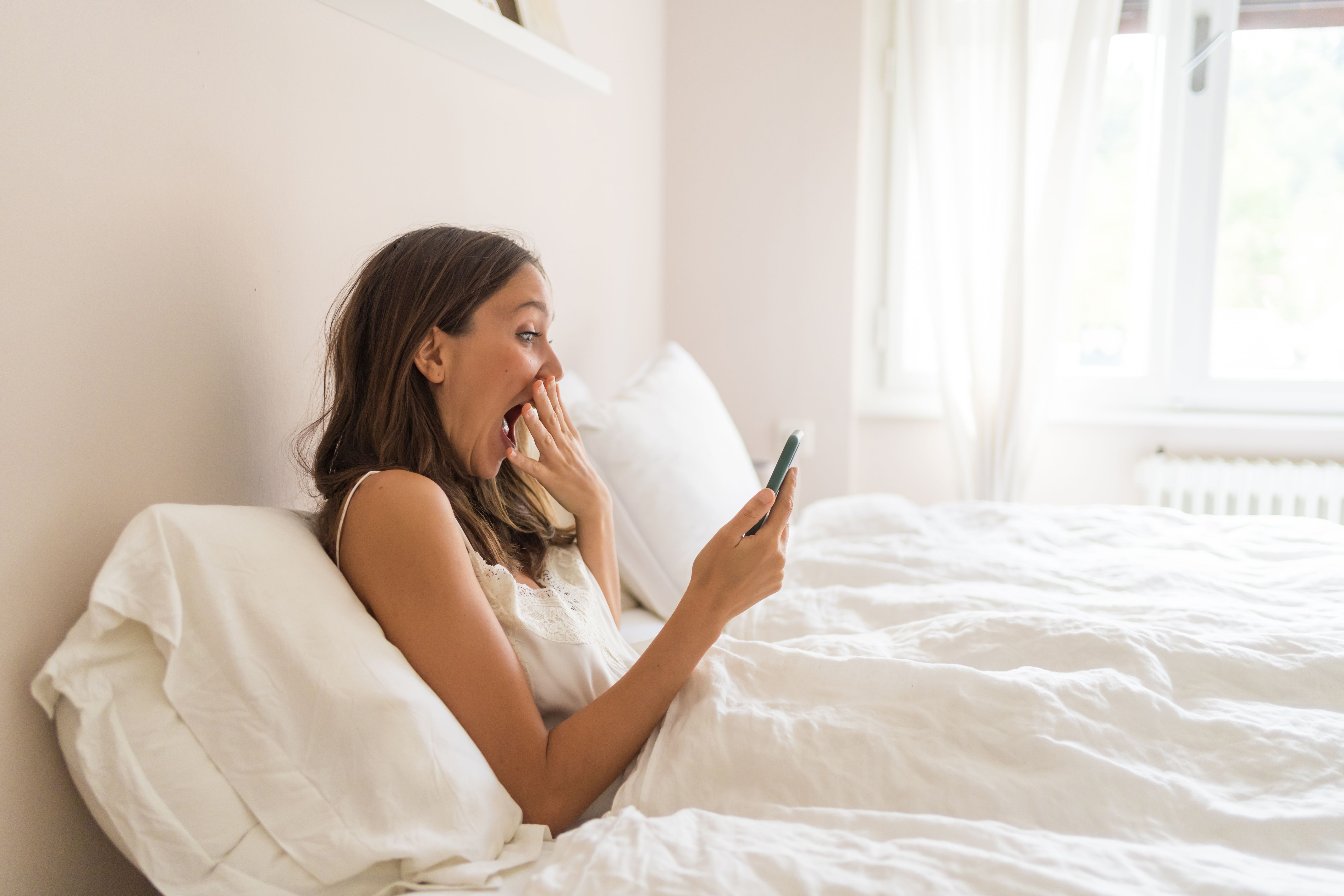 Young woman relaxes in bed, in the morning Young woman relaxes in bed, in the morning