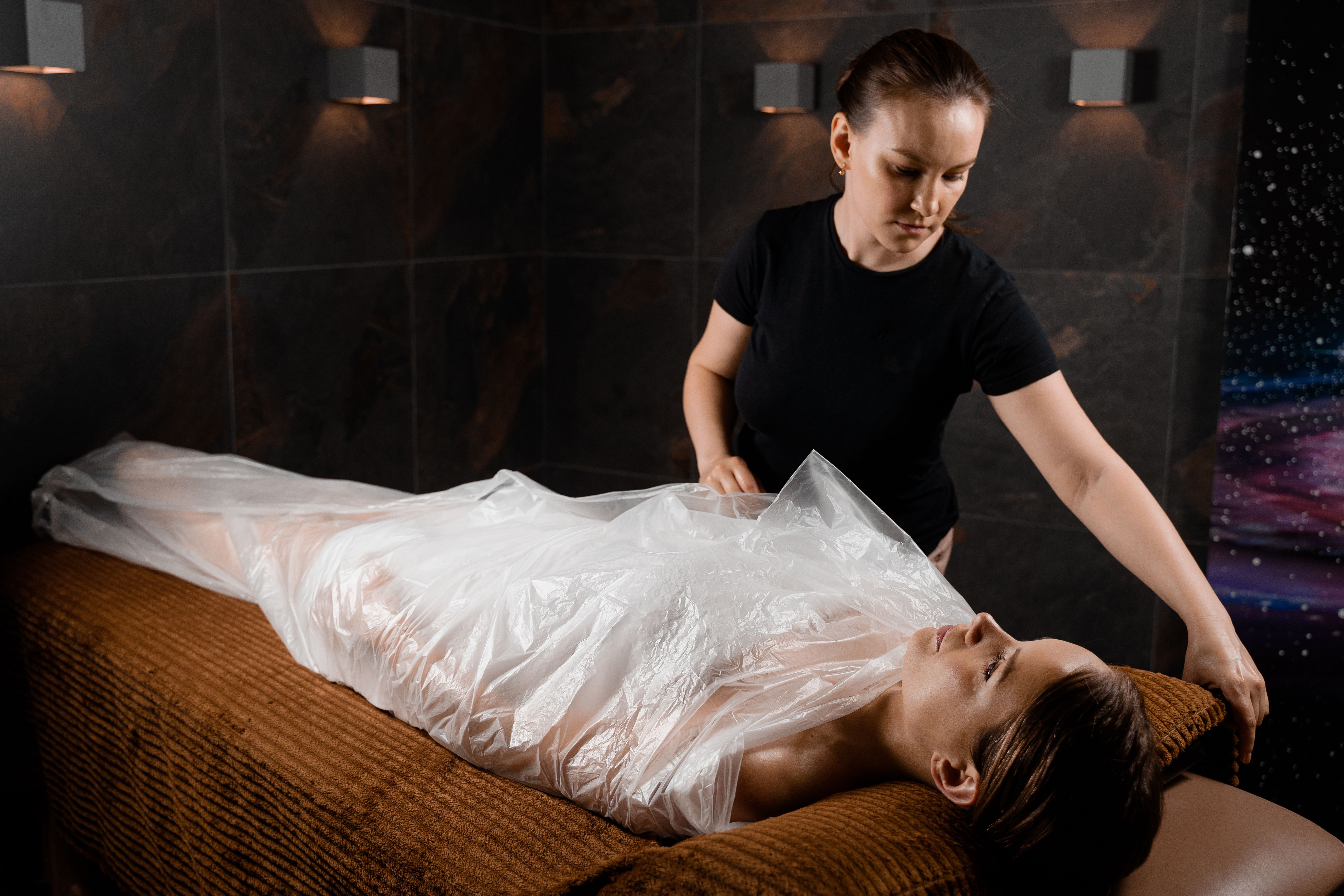Woman wrapped in a polyethylene wrap. Chocolate Spa therapy