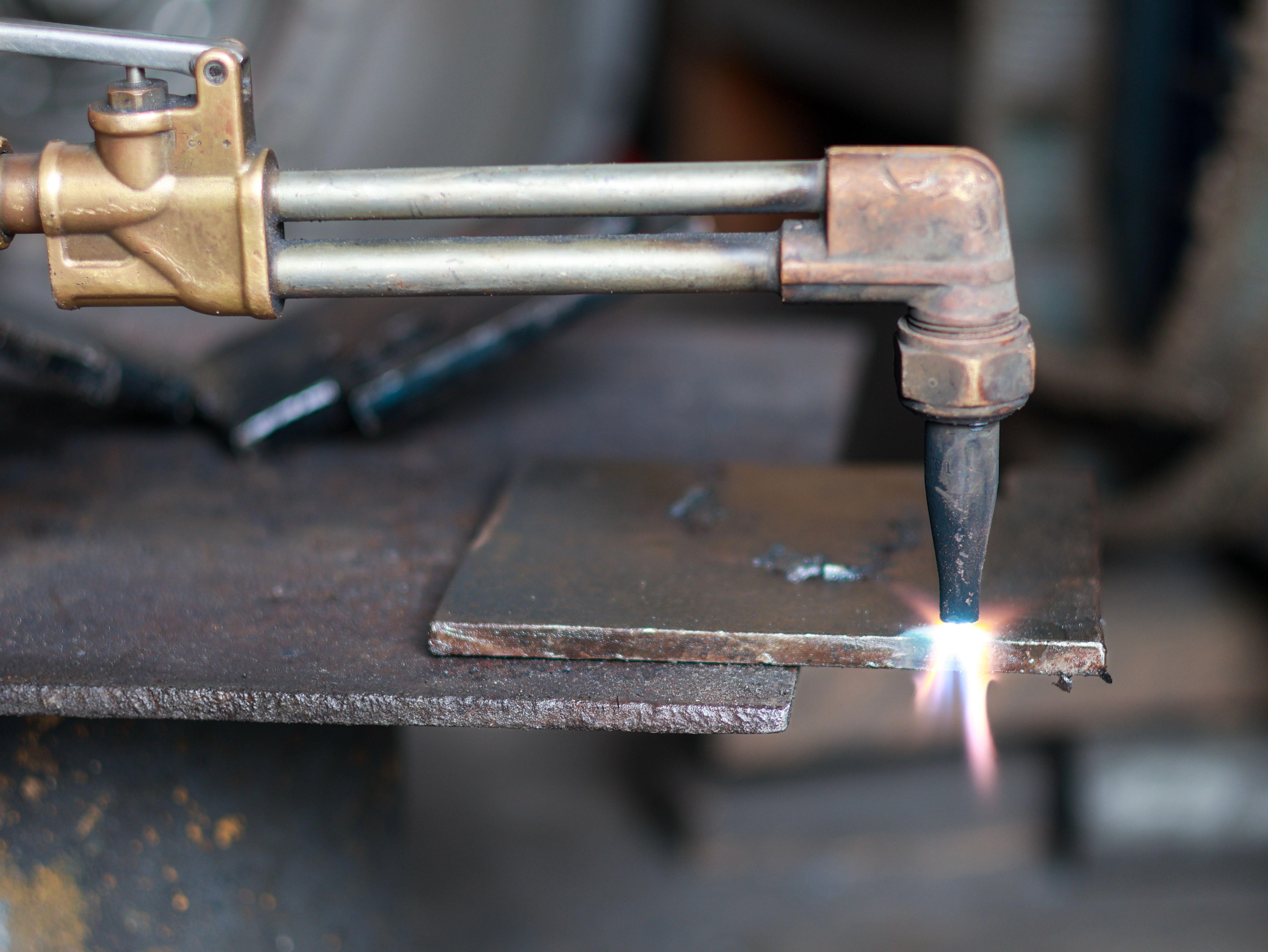 A torch acetylene gas cutting metal with bright sparks