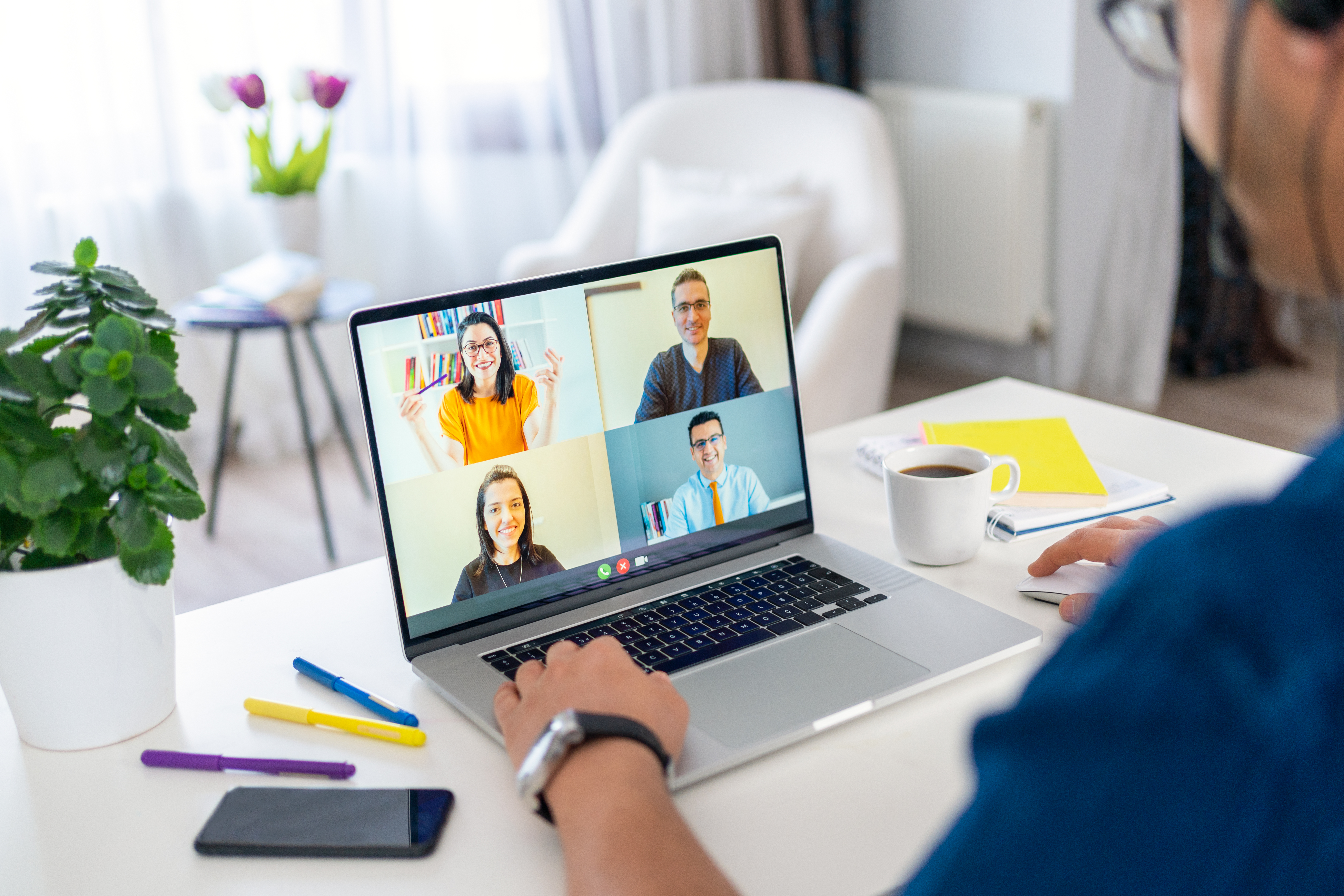 Businessman talking to his colleagues about business plan in video conference at home. Business team having discussion and online meeting in video call Businessman talking to his colleagues about business plan in video conference at home. Business team having discussion and online meeting in video call