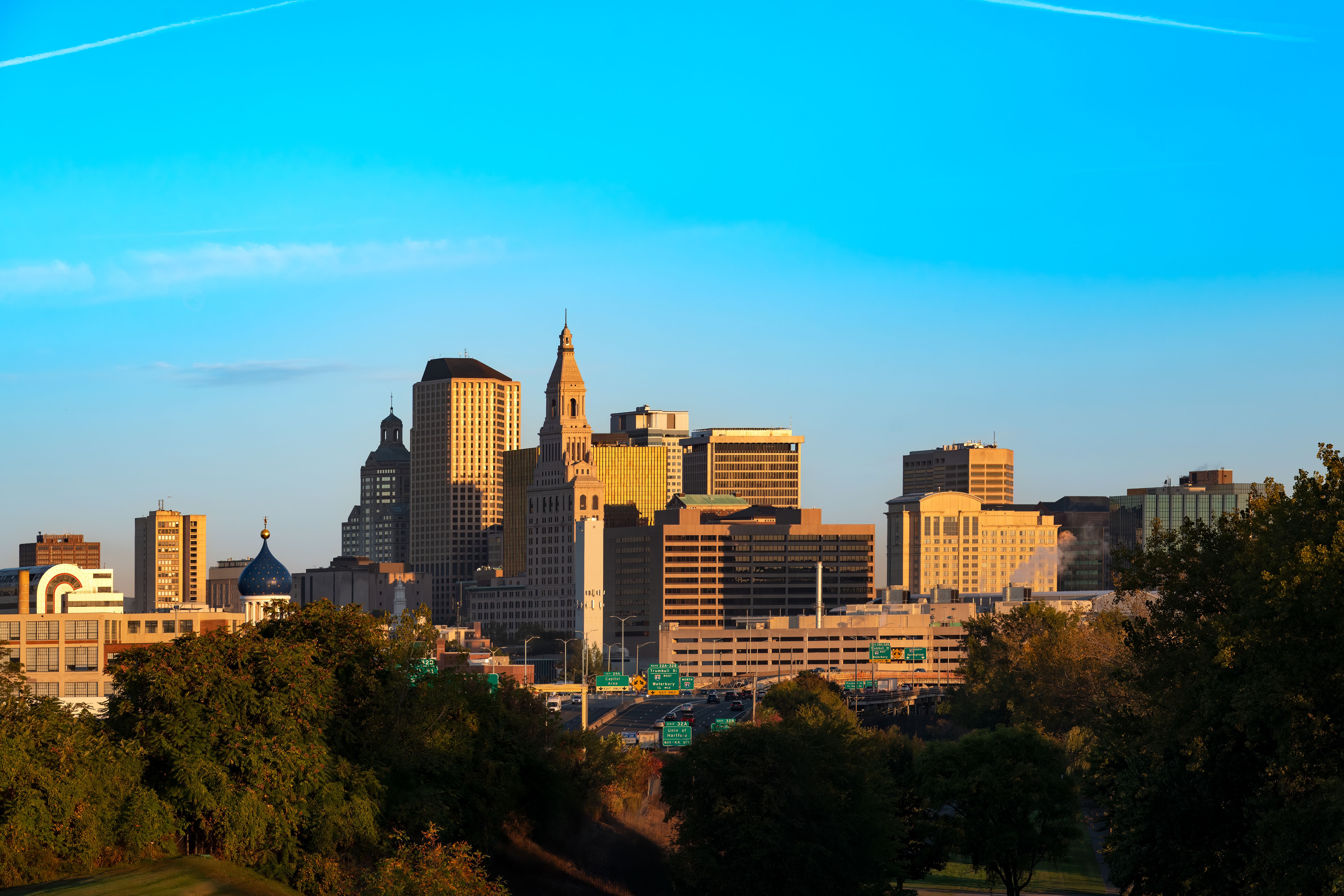 The golden light of dawn illuminates the towering architecture of downtown Hartford, Connecticut.