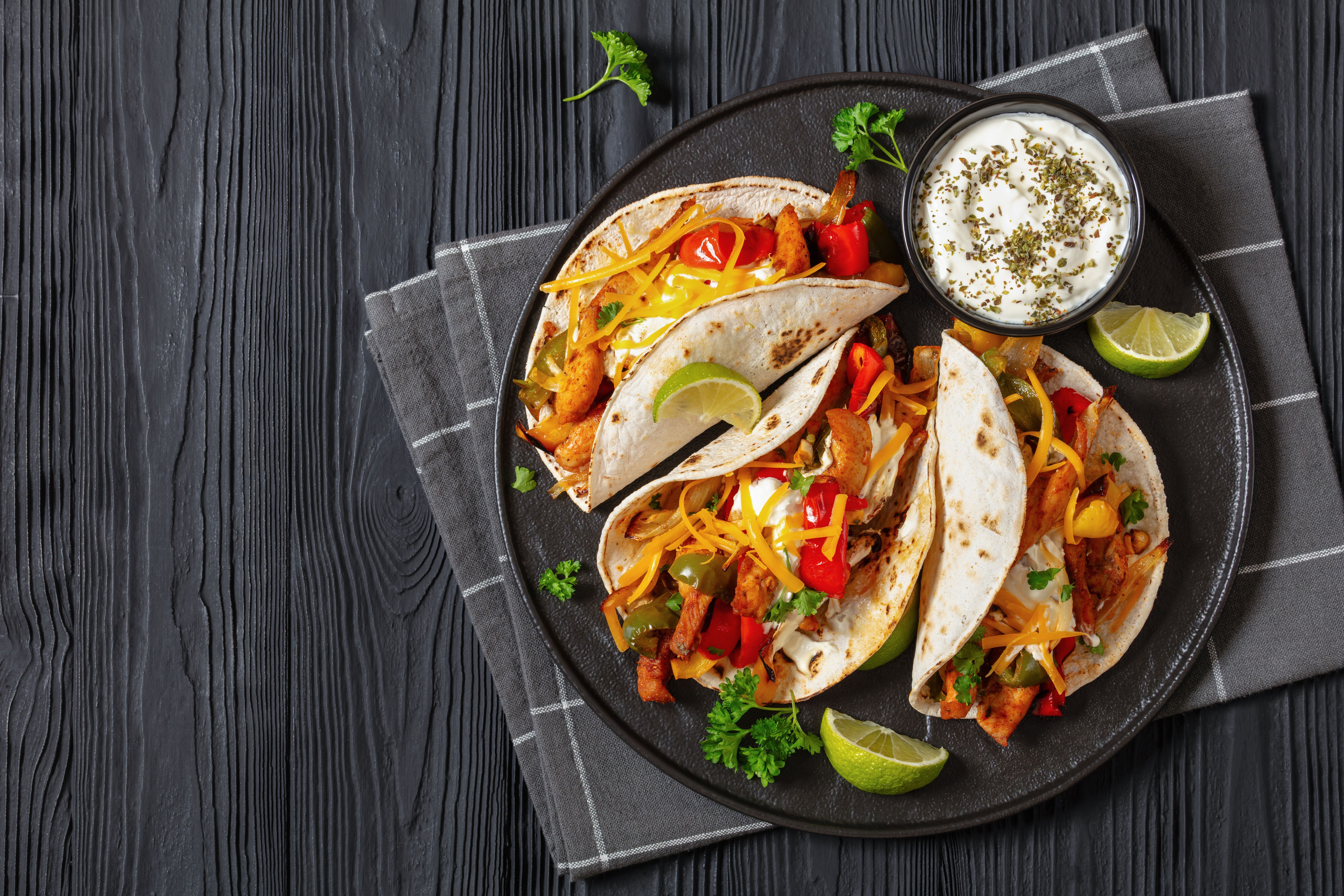 baked tex-mex chicken fajitas on a plate, top view baked tex-mex chicken fajitas on a plate, top view