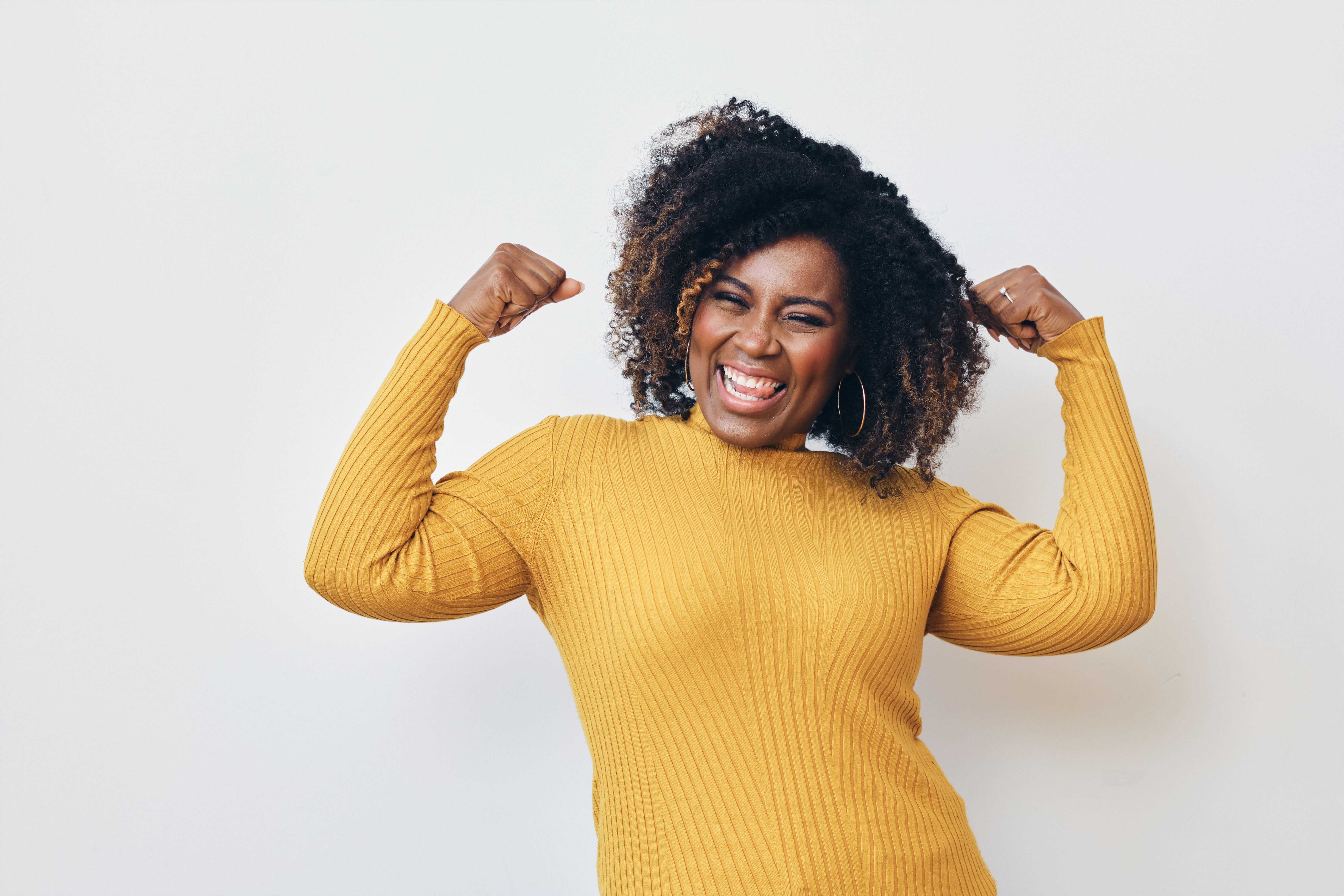 Cheerful strong woman flexing muscles against white background Cheerful strong woman flexing muscles against white background