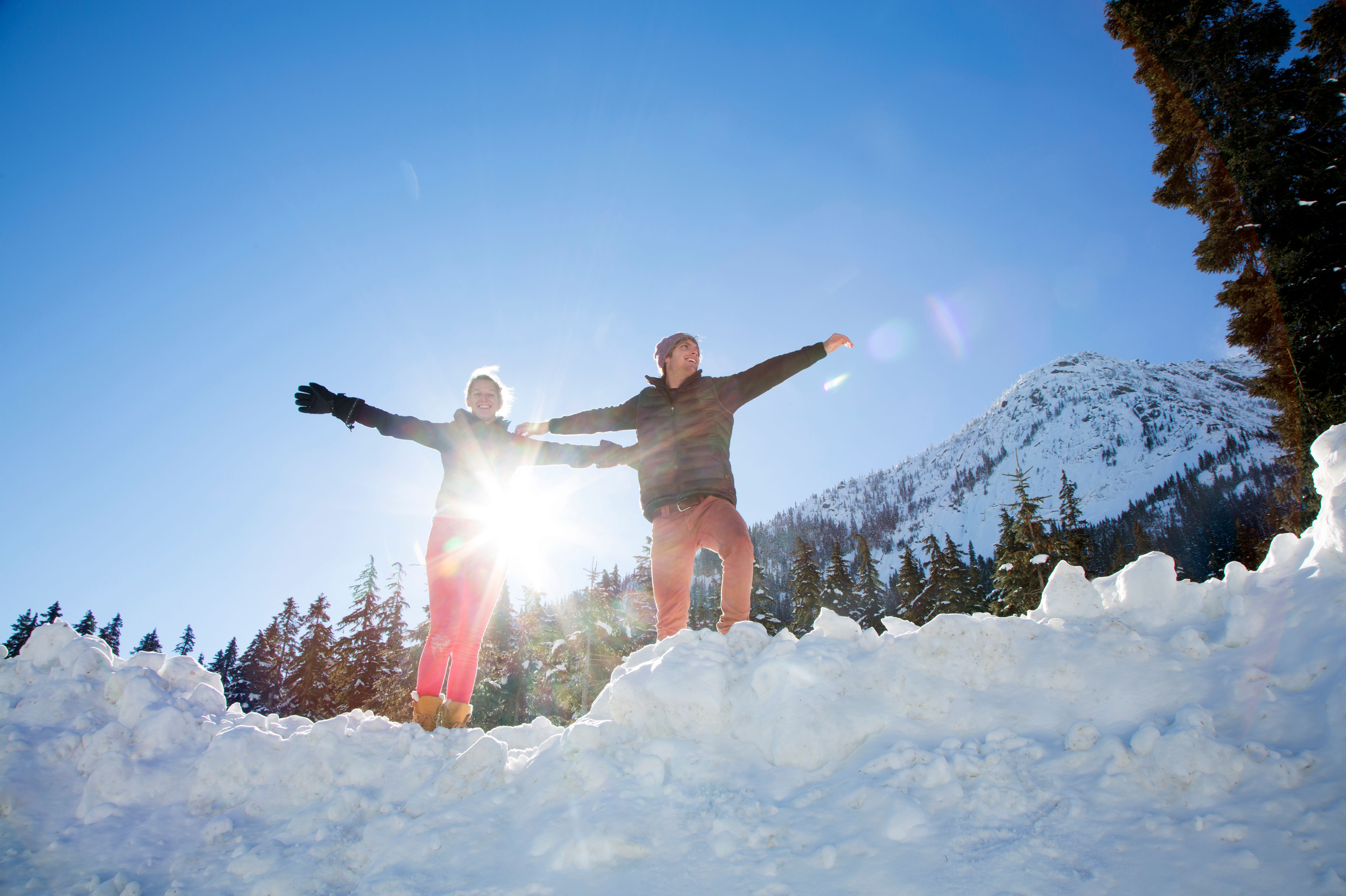 Young couple enjoy snowball fight