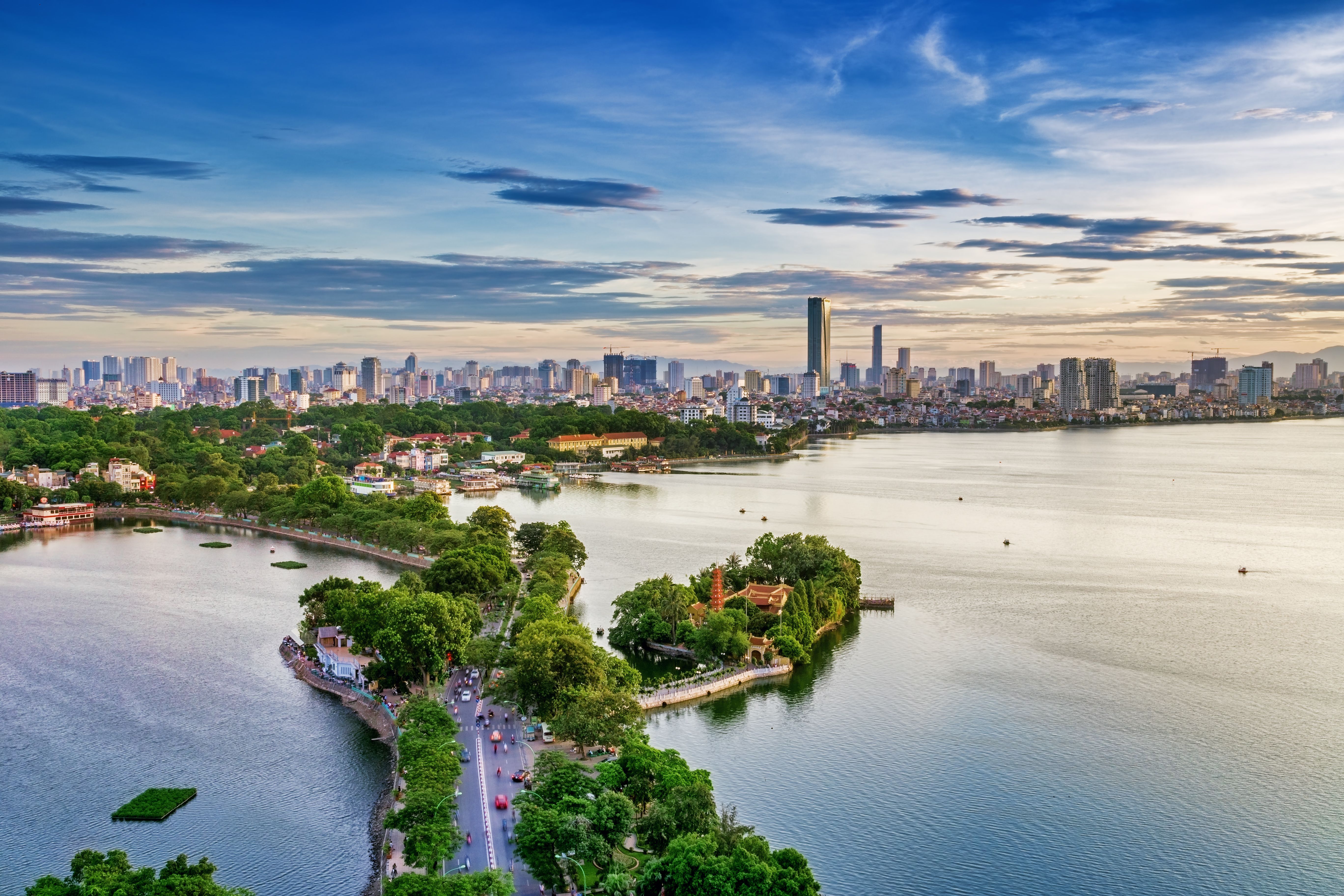 City At Waterfront Against Cloudy Sky