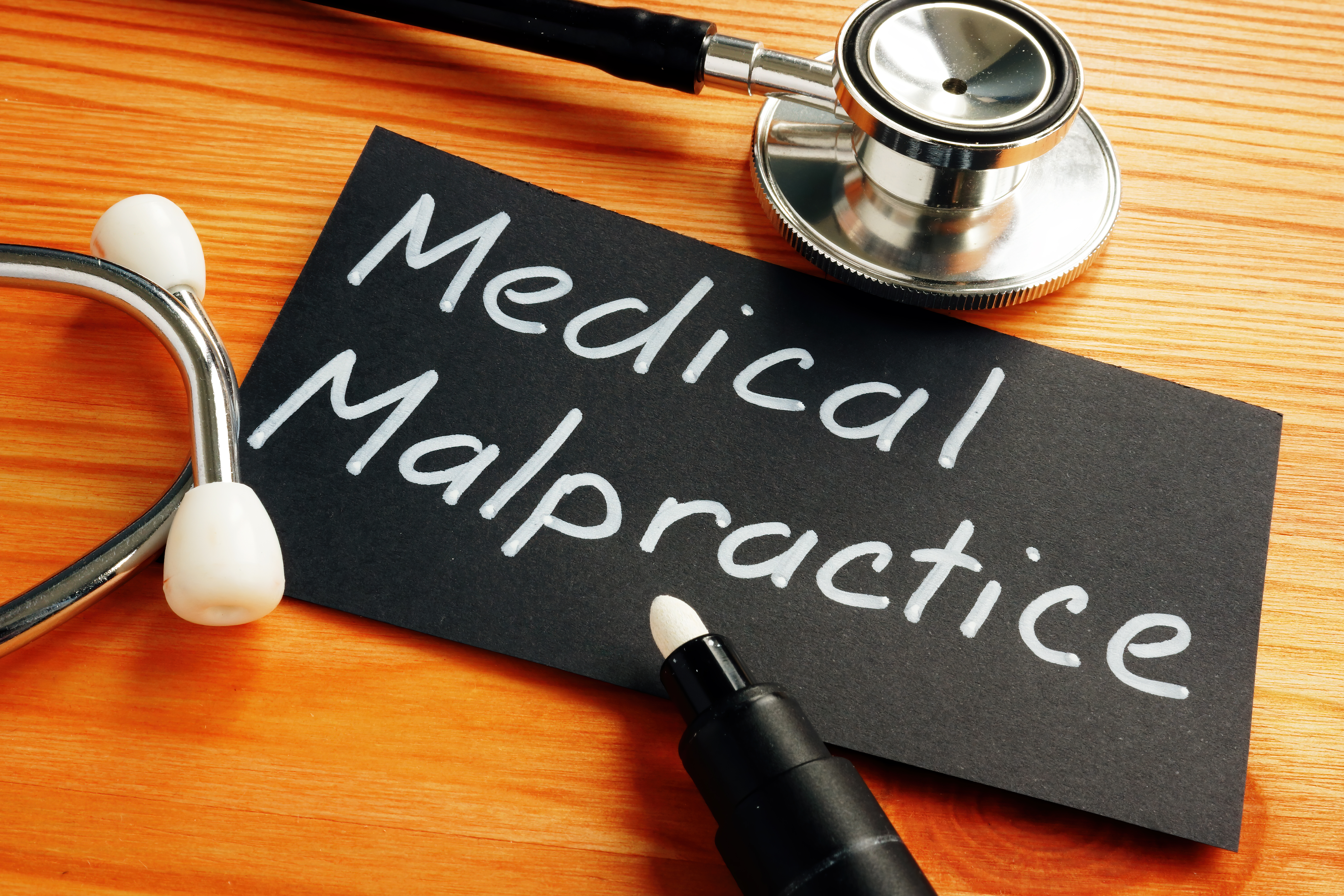 Business photo shows hand written text Medical Malpractice