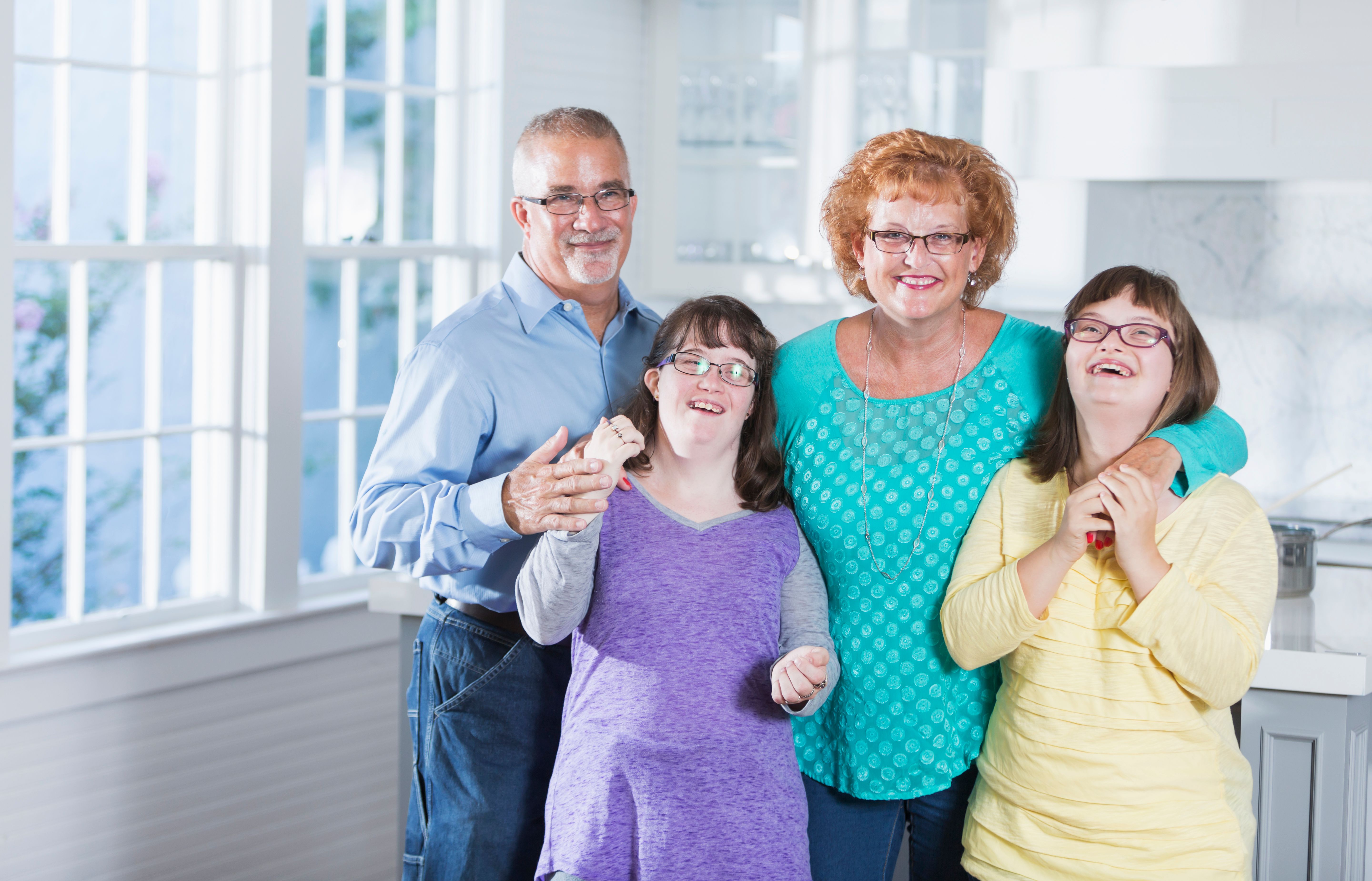 Loving family, daughters with down syndrome, at home