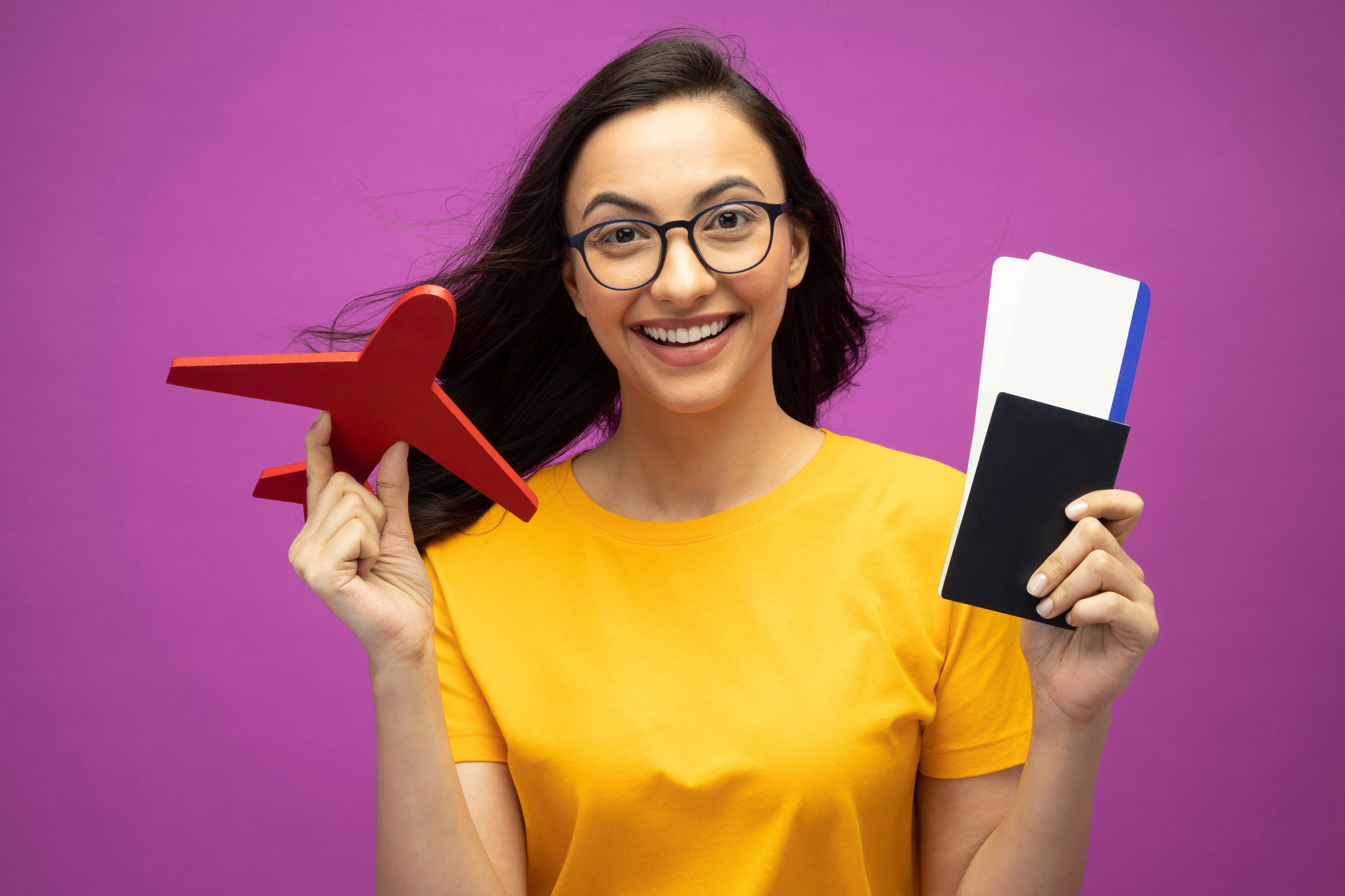 Photo of cute pretty beautiful girl wearing yellow t-shirt on isolated purple background stock photo