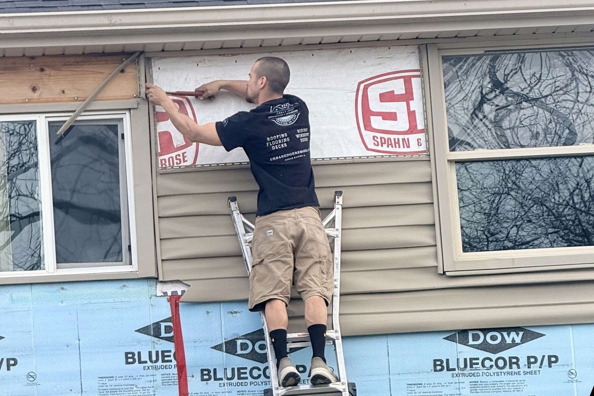 Matt of Urban Edge Construction & Remodeling installing new siding on a home in Cedar Rapids, Iowa