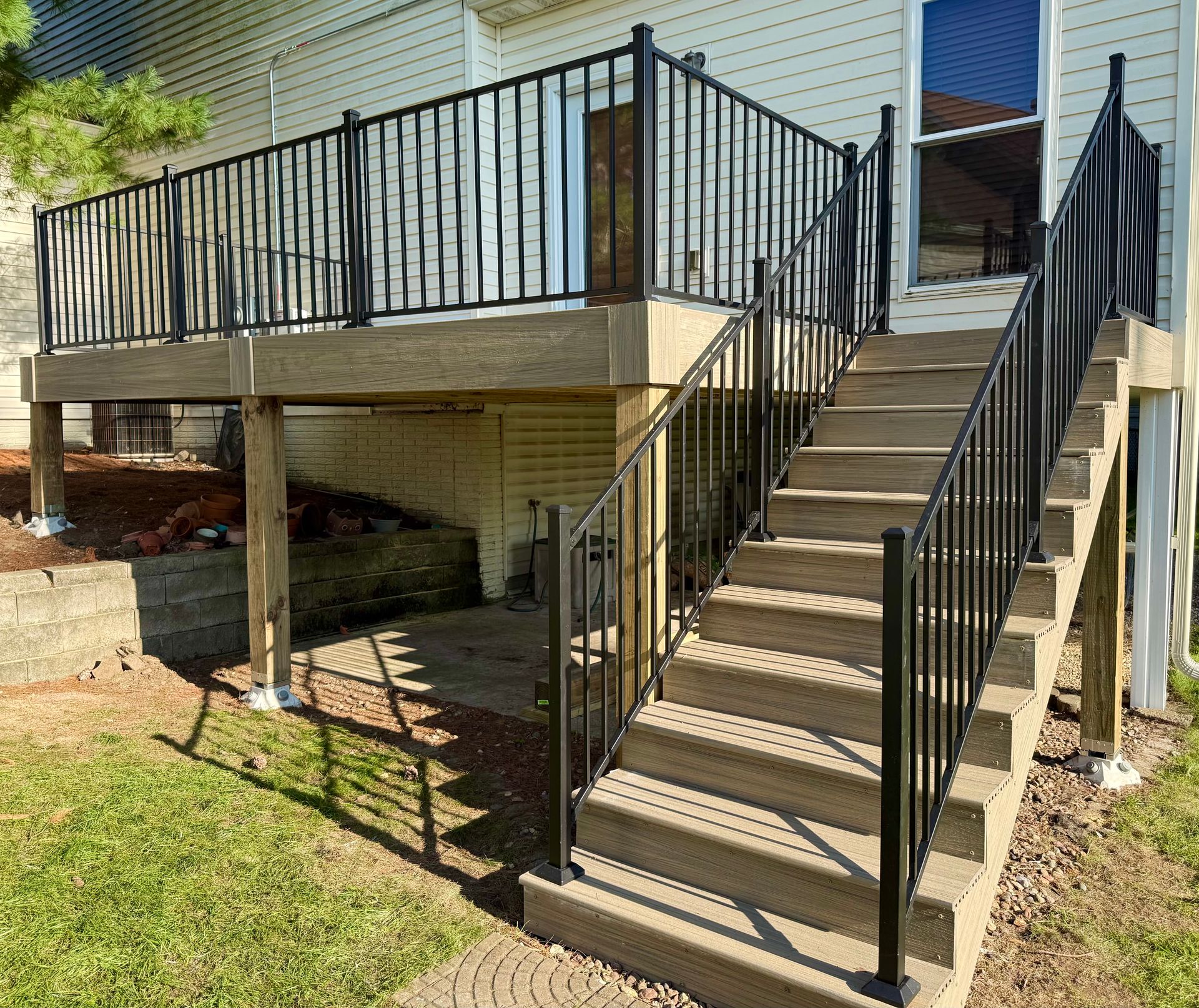 Composite deck build with railings by Urban Edge Construction in Cedar Rapids, Iowa