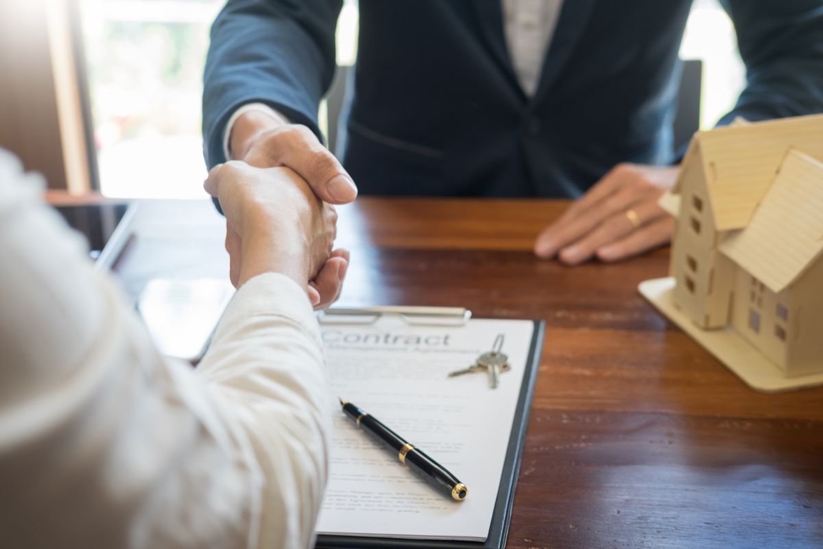 House developers agent or financial advisor and customers shaking hands after signing document making deal as successful agreement, contract with a firm House developers agent or financial advisor and customers shaking hands after signing document making deal as successful agreement, contract with a firm