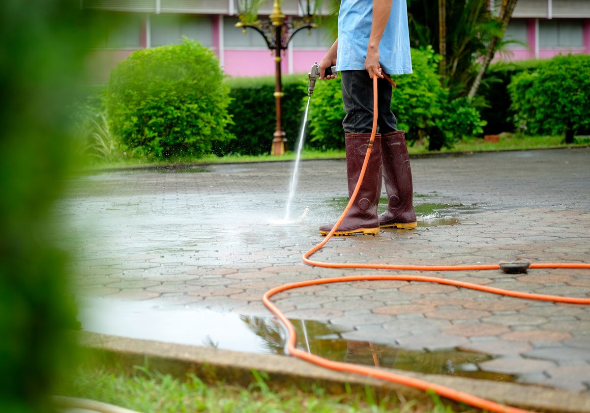 worker spraying water to clean the floor. worker spraying water to clean the floor.