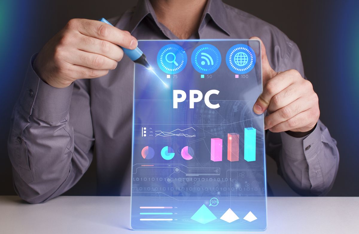 Business, Technology, Internet and network concept. Young businessman working on a virtual screen of the future and sees the inscription: PPC