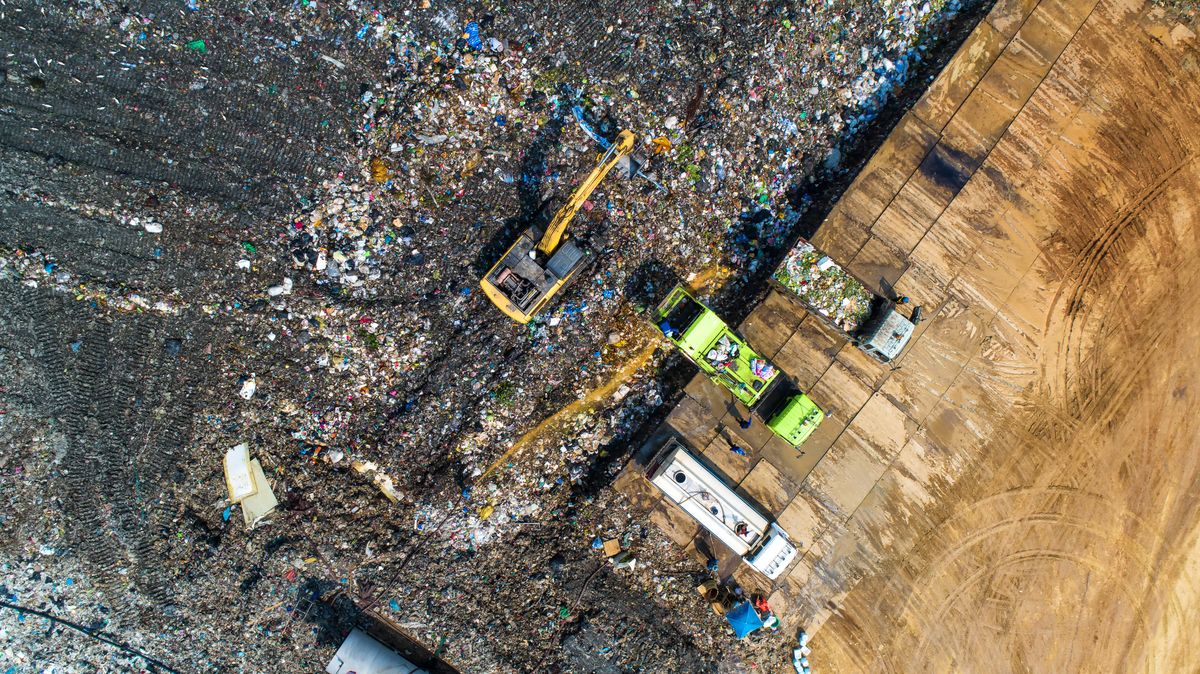 A lot of waste is disposed of in the waste disposal pits. Loaders is working on a mountain garbage. Aerial view and top view. A lot of waste is disposed of in the waste disposal pits. Loaders is working on a mountain garbage. Aerial view and top view.