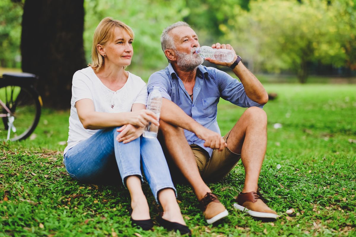 elder family in park with drinking water relax after exercise