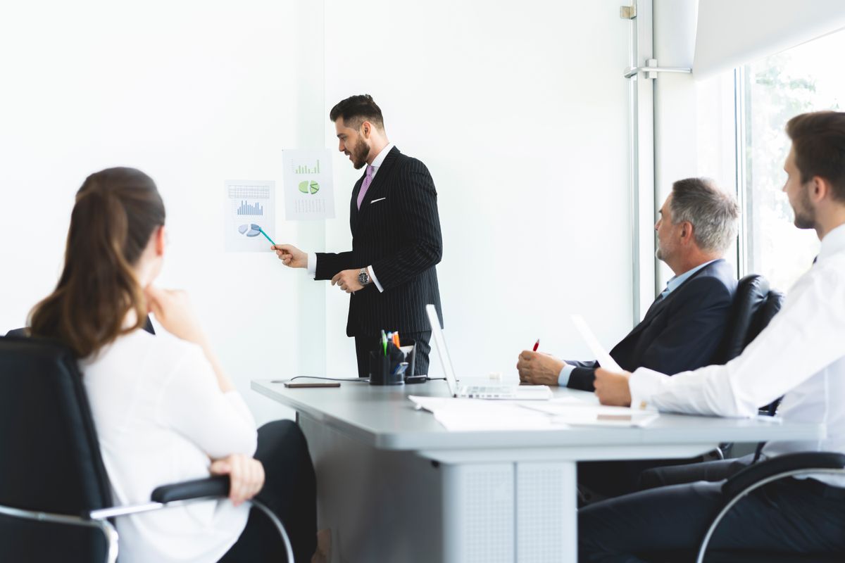 Businessman presenting to colleagues at a meeting Businessman presenting to colleagues at a meeting