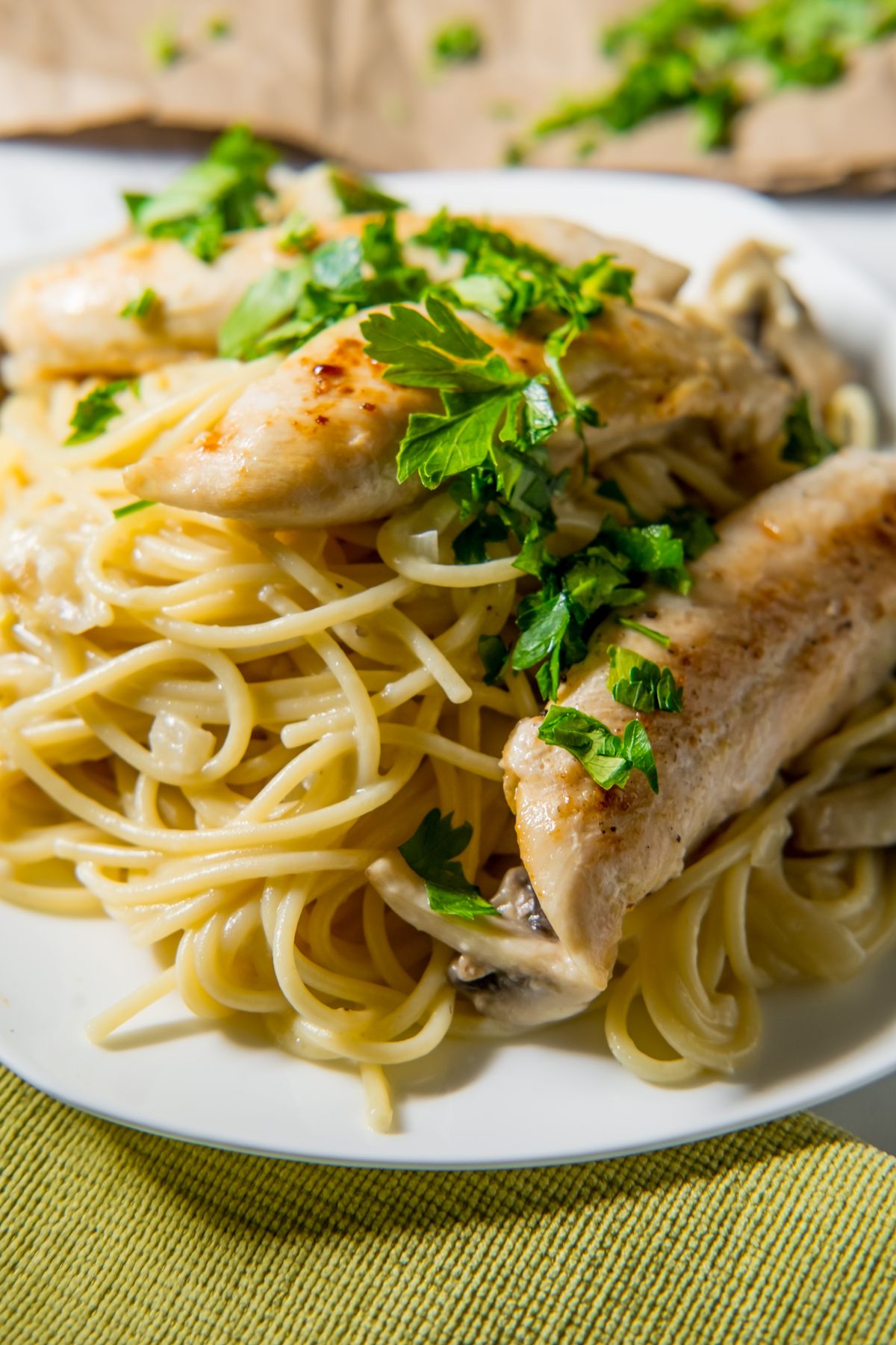 Grilled chicken with creamy garlic mushroom cheese sauce on Italian spaghetti