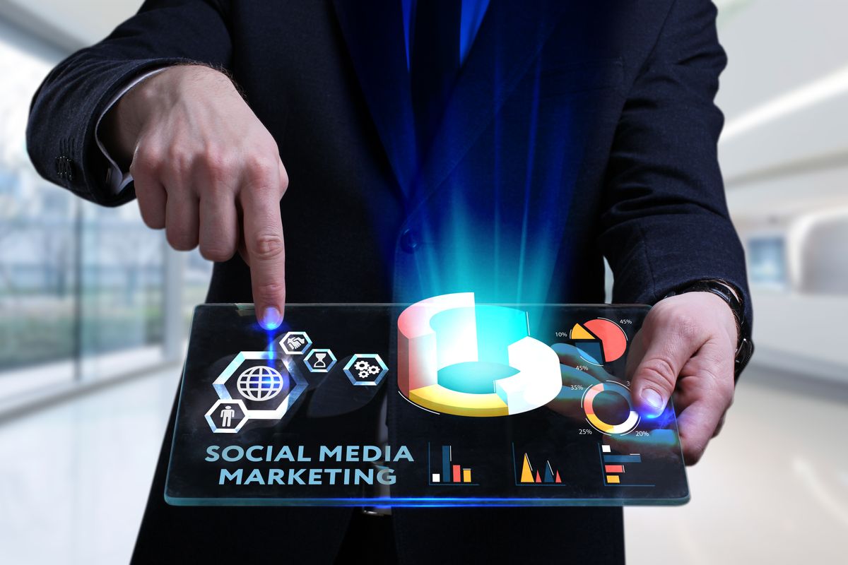 Business, Technology, Internet and network concept. Young businessman working on a virtual screen of the future and sees the inscription: Social media marketing