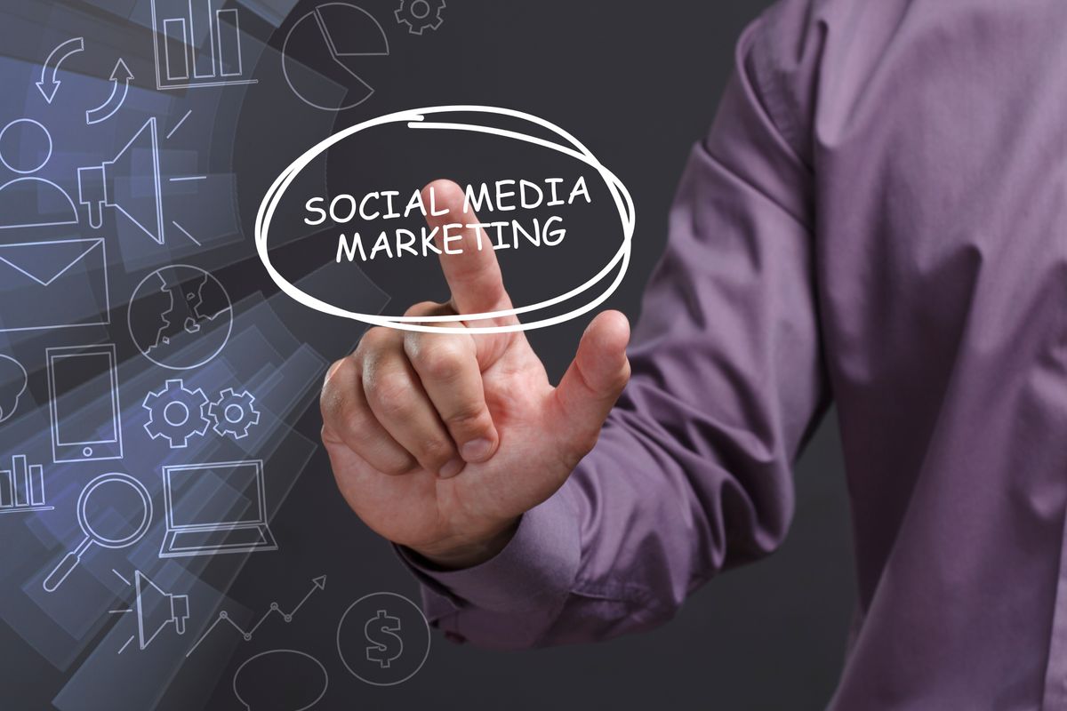 Business, Technology, Internet and network concept. Young businessman shows the word: Social media marketing